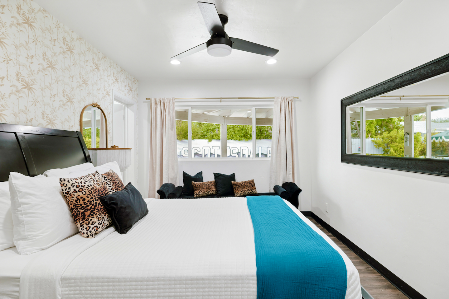 Queen bedroom with chaise lounge and wall mirror