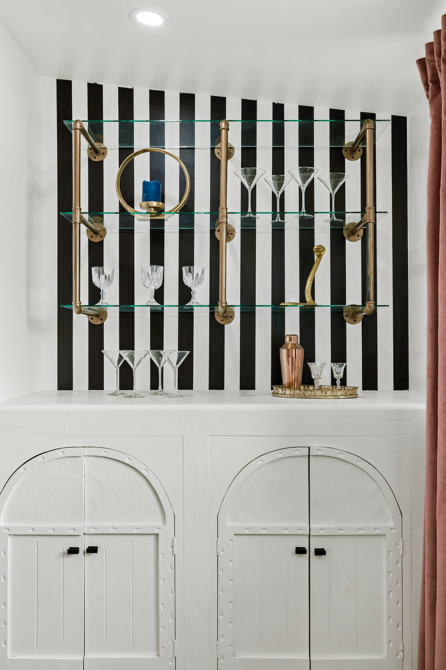 Dry bar with glass shelves and gold accents