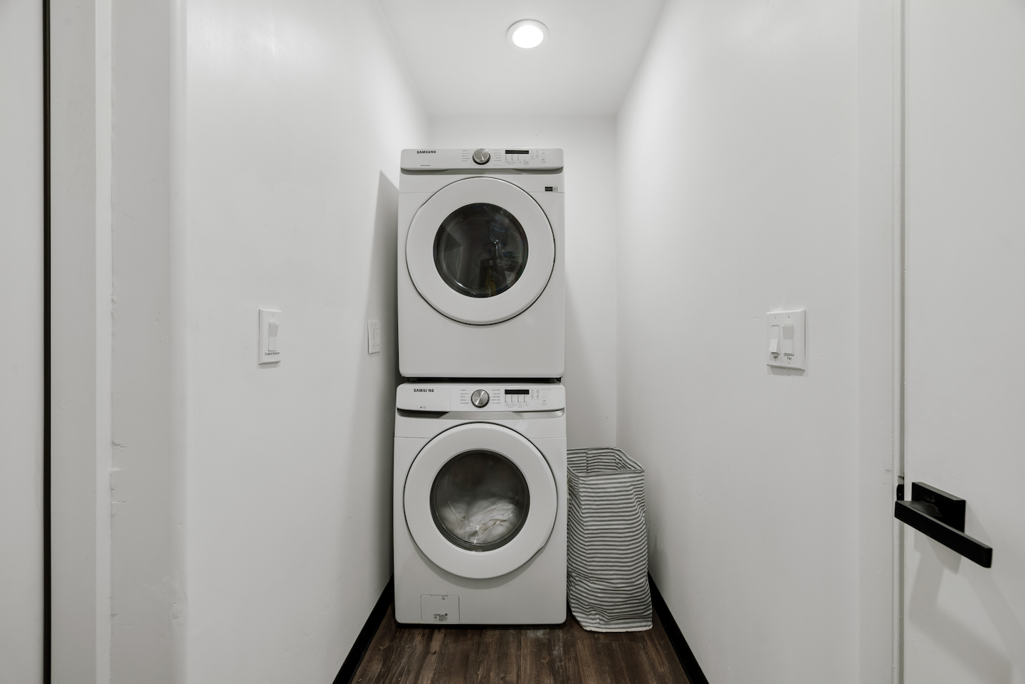 Laundry room with stacked washer and dryer