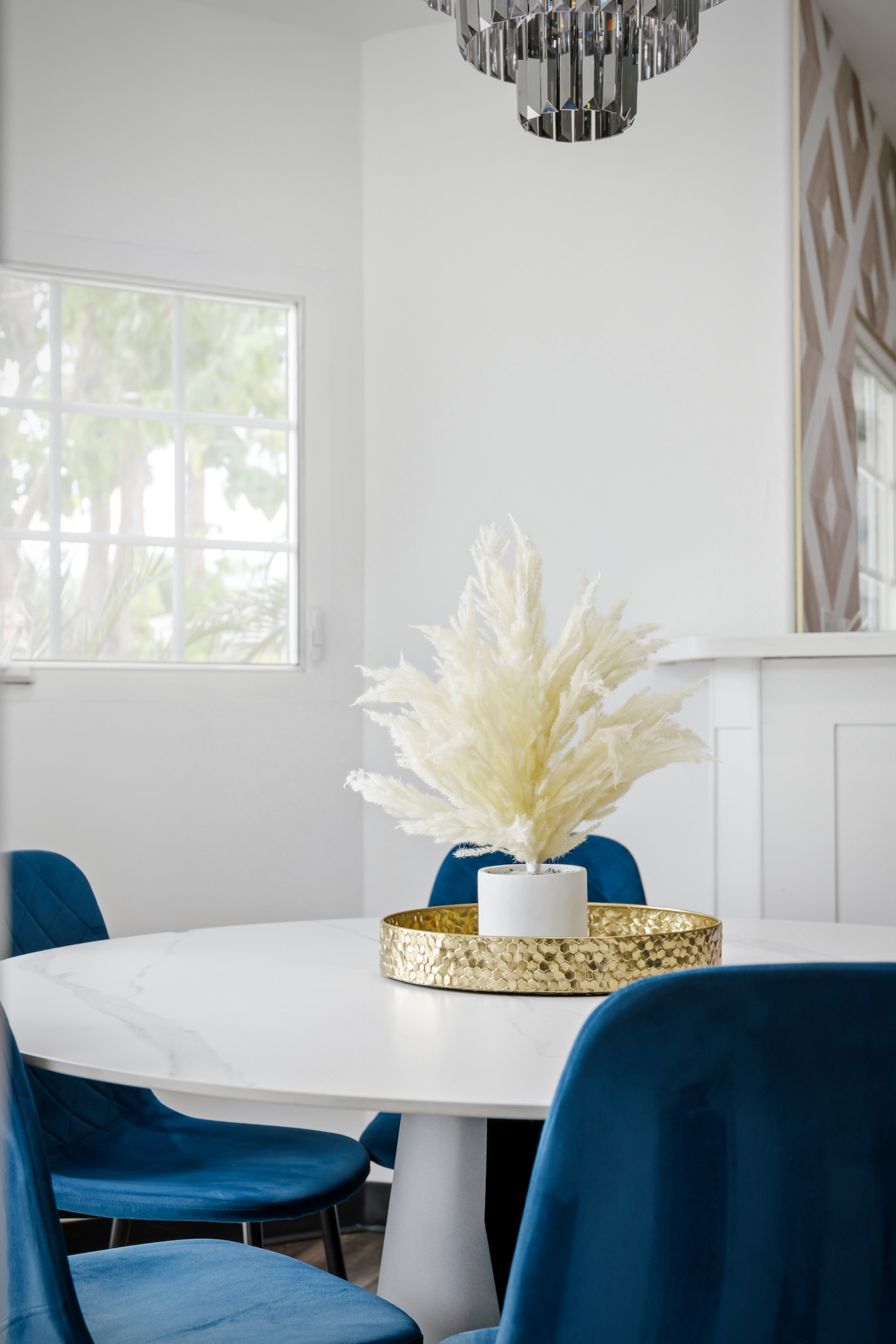 Round dining table with blue velvet chairs