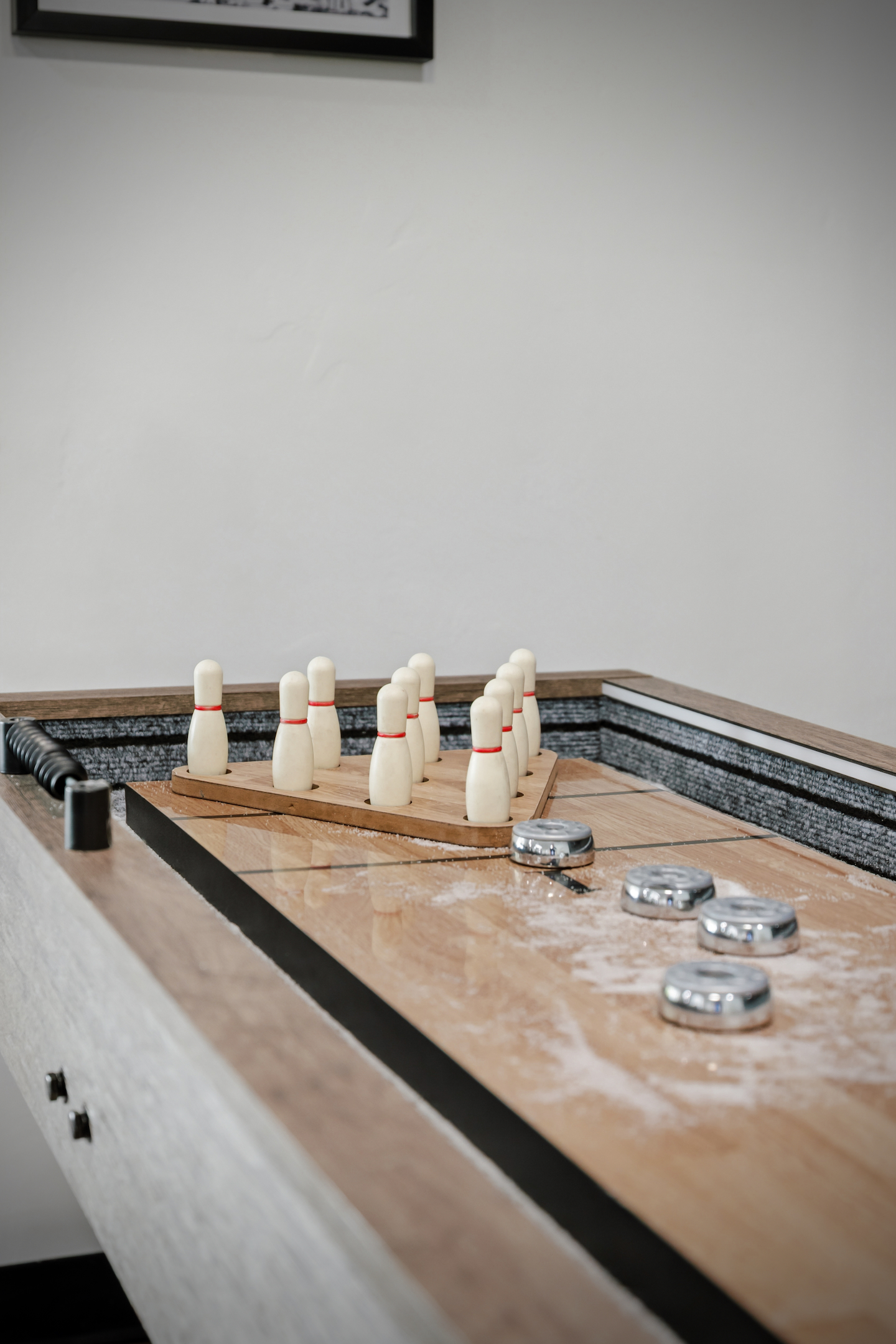 Shuffleboard table with pucks and bowling pin set