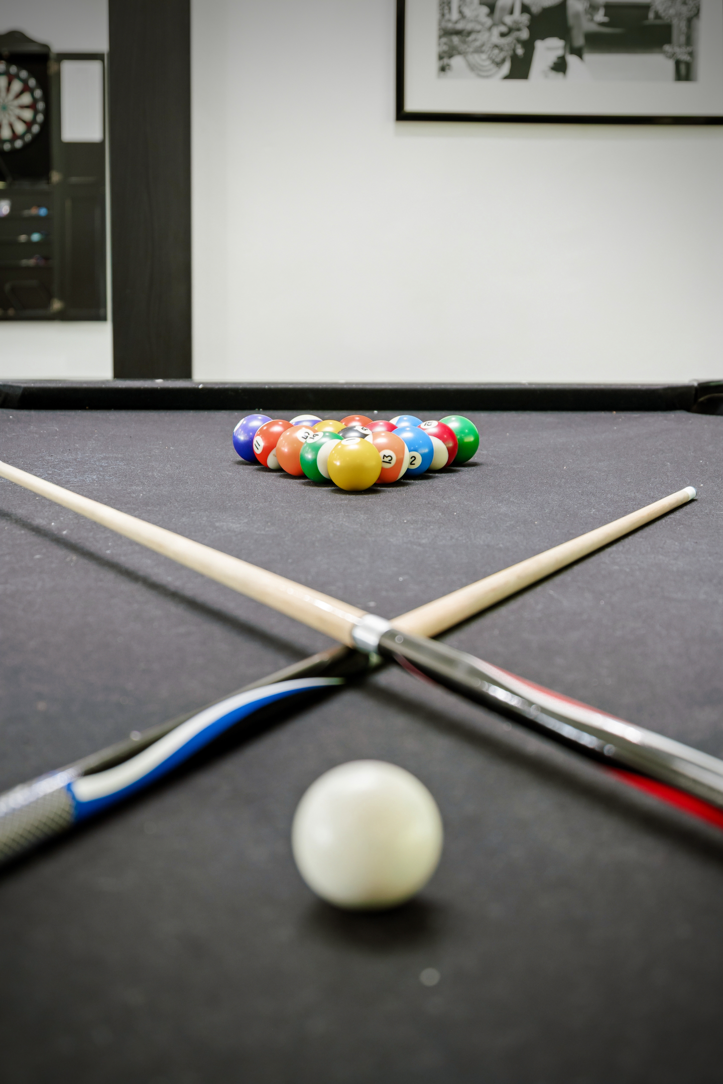 Pool table with cues and balls racked