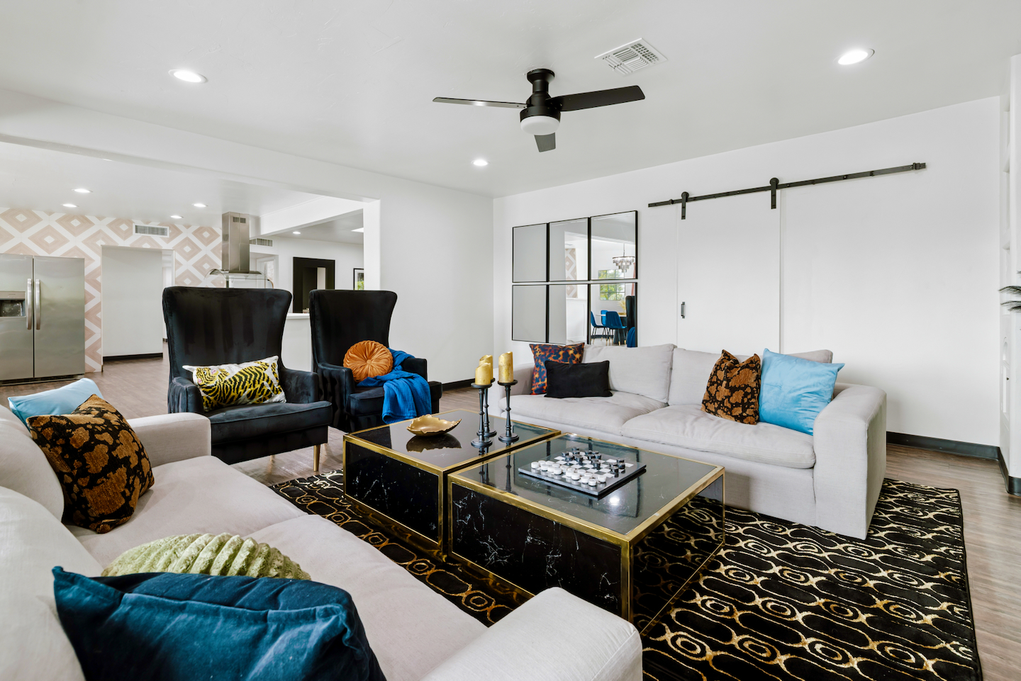 Living room with velvet wingback chairs and sofas
