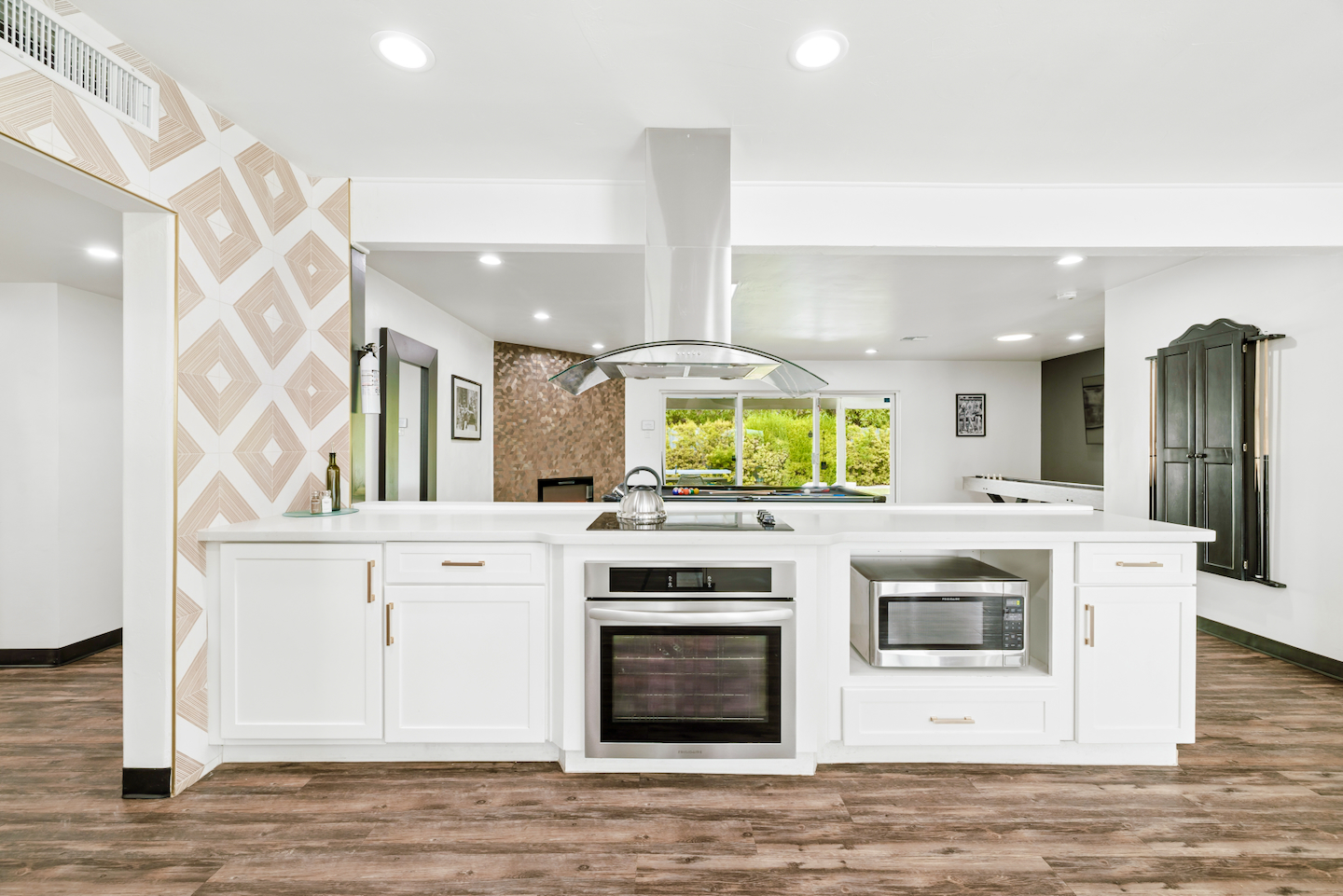 Kitchen island with cooktop, wall oven and microwave
