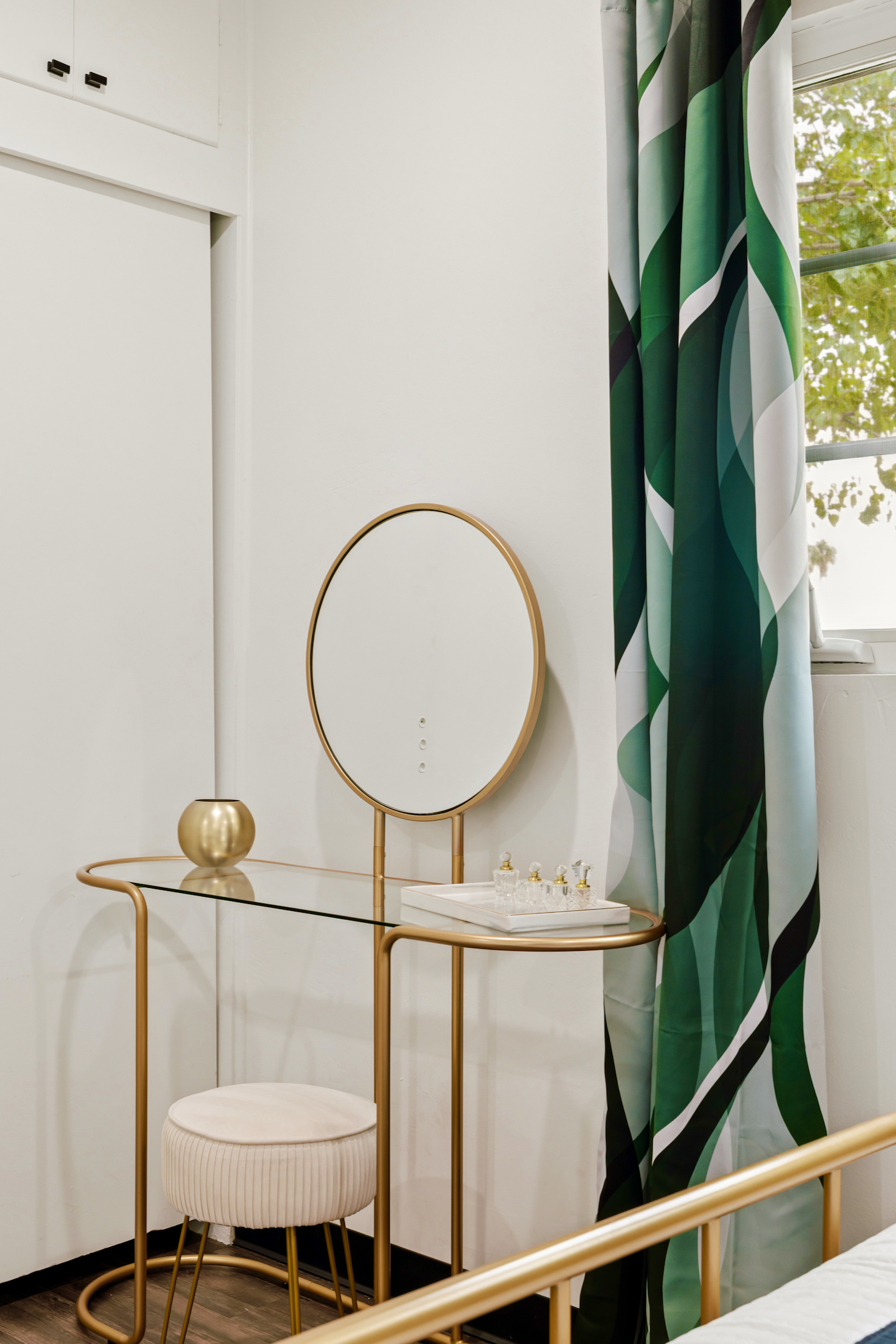 Vanity with round gold mirror