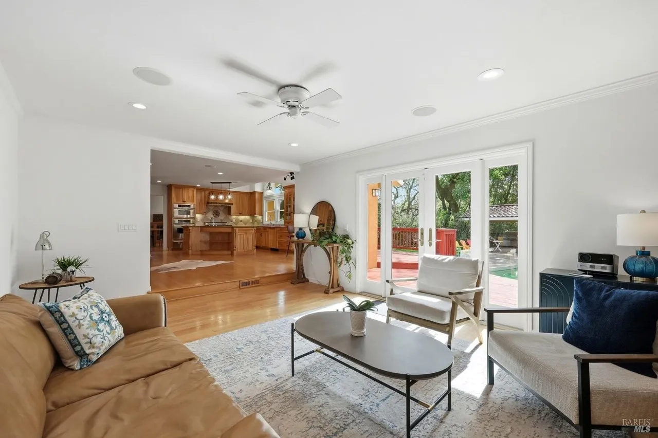 Bright open living room with deck access and seamless kitchen flow