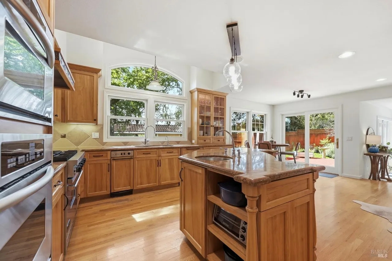 Bright open kitchen with large island and seamless patio access