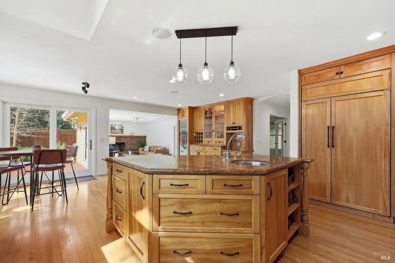 Bright gourmet kitchen with large island and seamless indoor-outdoor flow