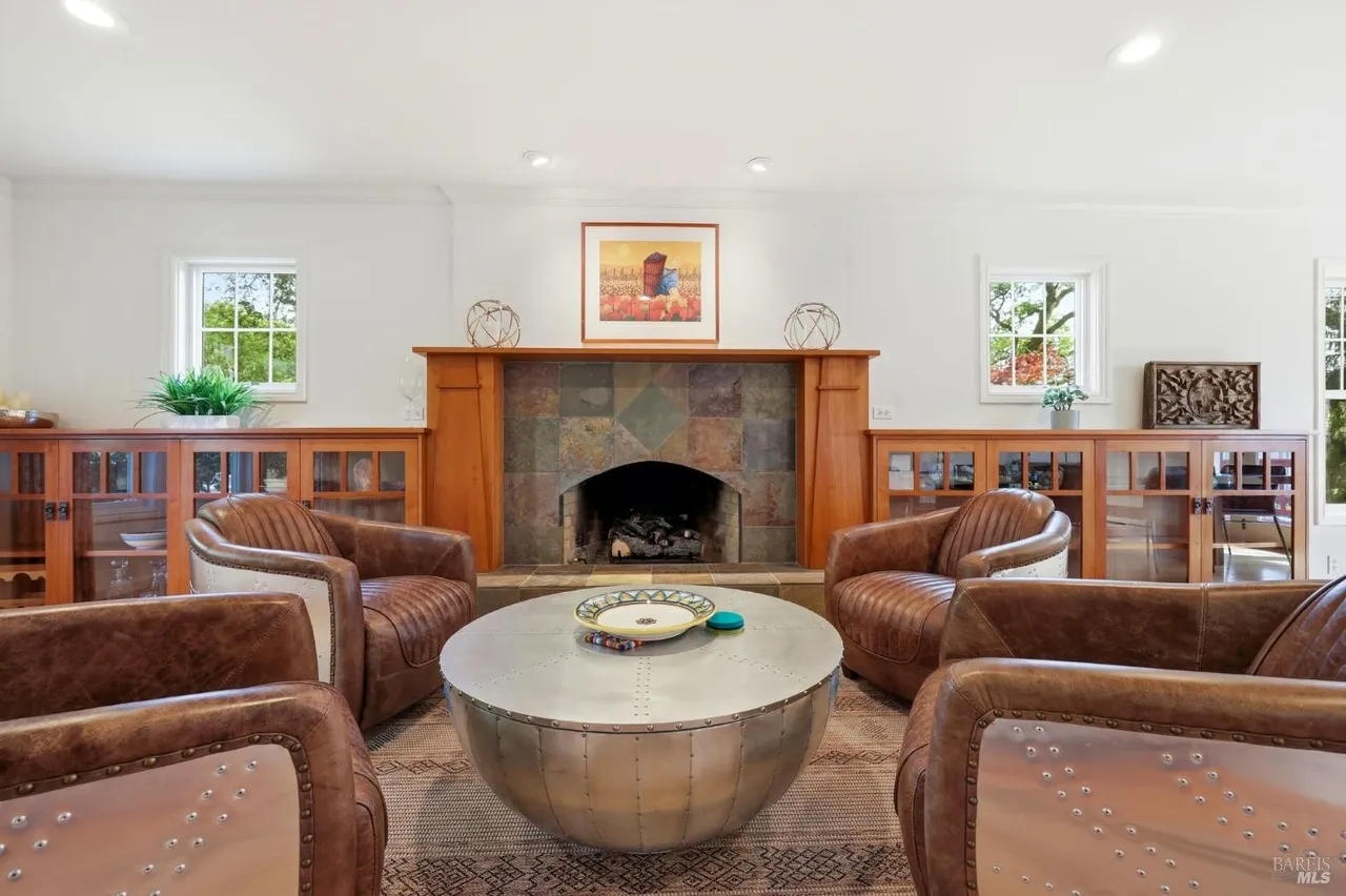 Bright lounge with stone fireplace and stylish leather seating