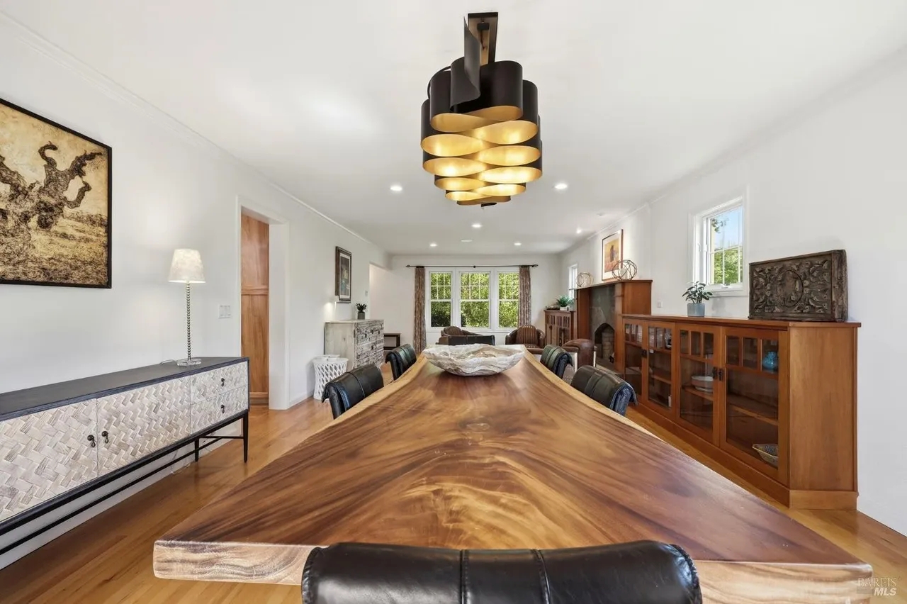 Spacious dining room with stunning live-edge table and designer lighting