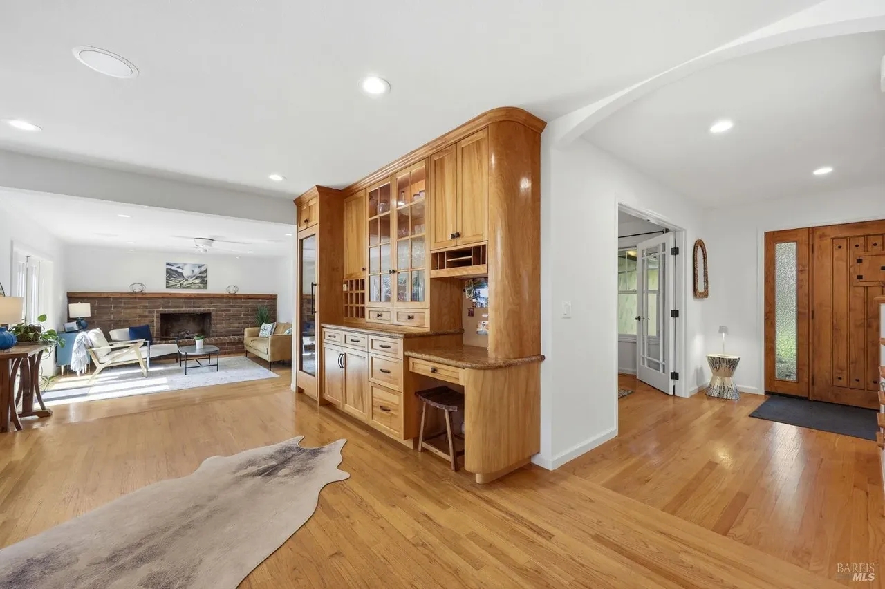 Bright open living space with hardwood floors and cozy fireplace