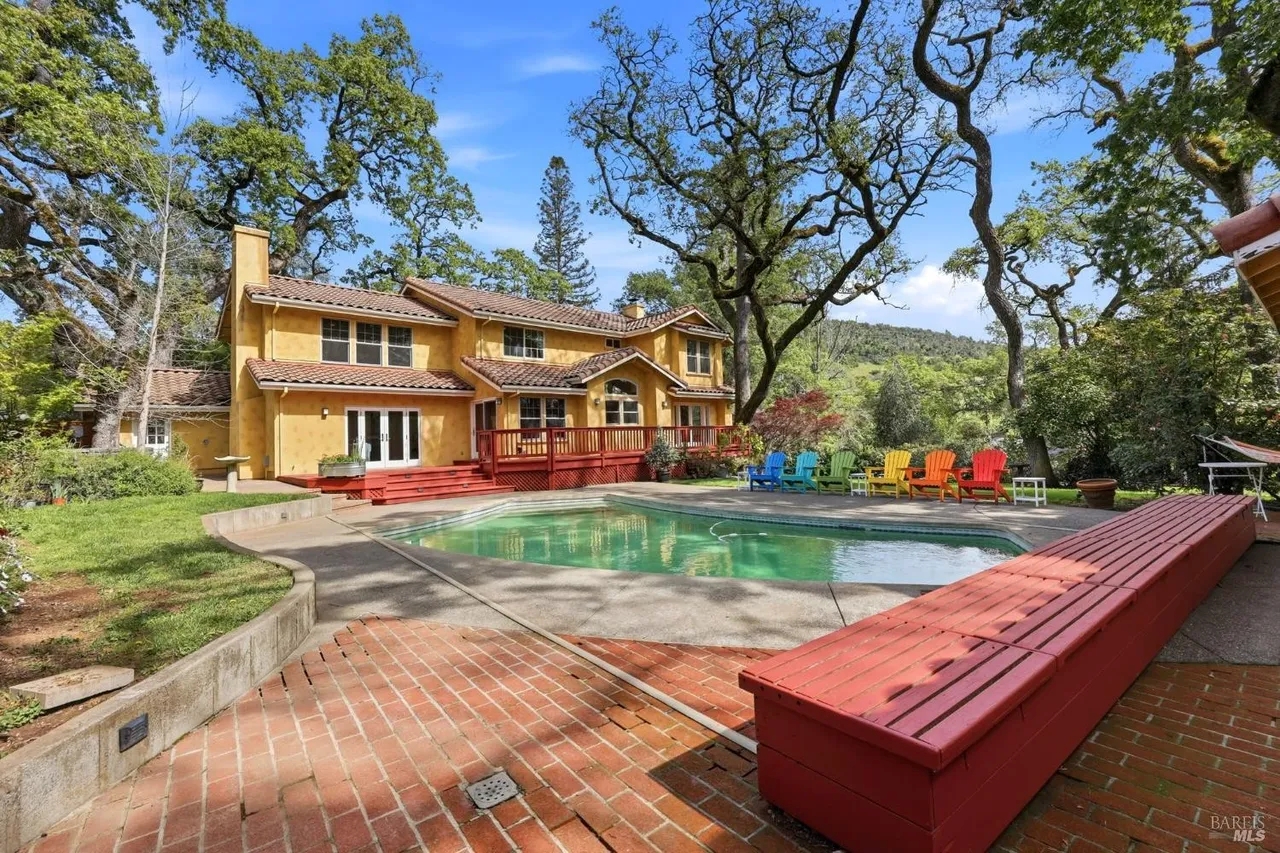 Private pool retreat with spacious patio and serene wooded setting