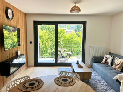 Bright living room with dining table and sofa bed