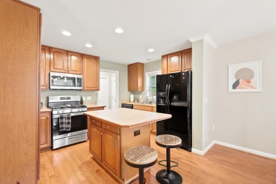 The kitchen brings serious energy to family meal time! Gather around the island for morning coffee, whip up a feast with full-size appliances, and let the sunlight bounce off those warm hardwood floors while the whole crew pitches in.