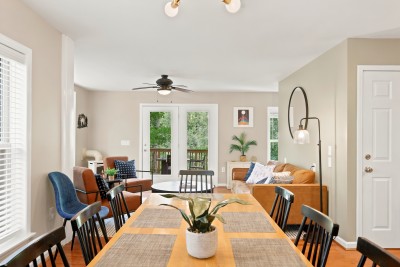 This bright, open living-dining space is made for gathering, with French doors that flood the room in natural light and open straight onto the outdoors, perfect for meals that flow right into mountain evenings.