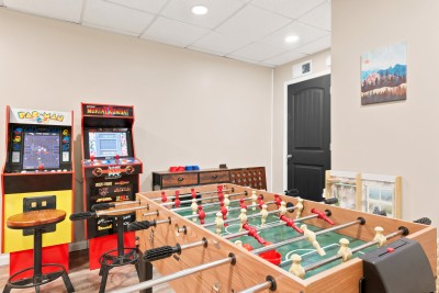 This private game room is stocked with a foosball table and classic arcade favorites, giving the whole group a dedicated space for friendly competition and non-stop fun between mountain adventures.