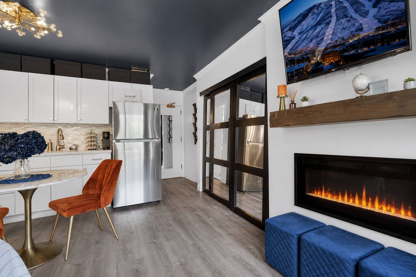 Modern studio with sleek kitchenette, fireplace, and smart design