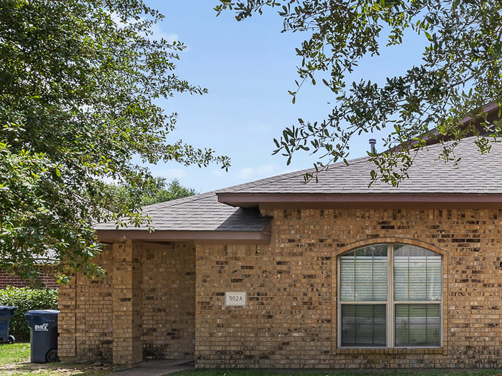 Charming brick home with shaded entry and welcoming curb appeal