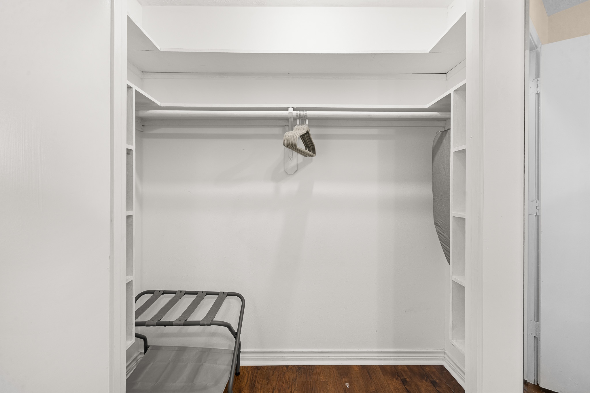 Spacious walk-in closet with built-in shelves and luggage space