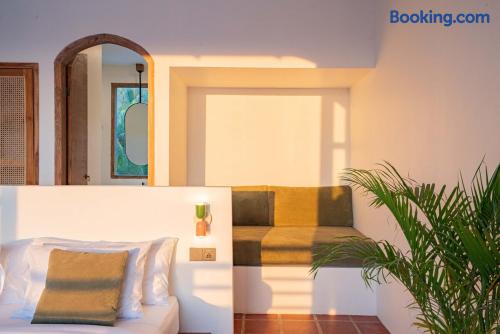 Sunlit bedroom with cozy built-in lounge and warm Mediterranean style