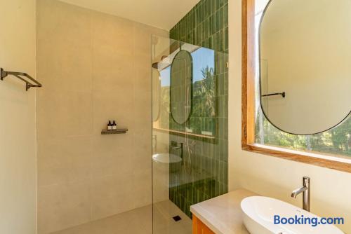 Bright spa-style bathroom with walk-in shower and nature views