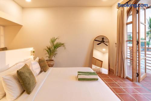 Bright minimalist bedroom with French doors opening to a private balcony