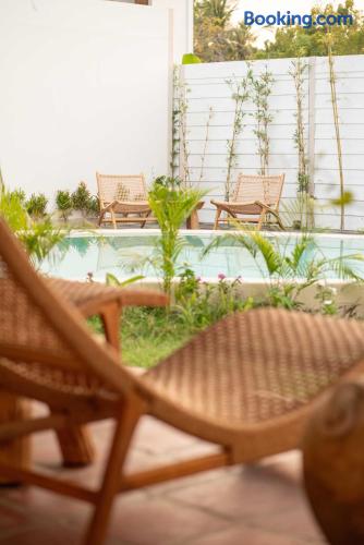 Private pool patio with tropical greenery and relaxing lounge chairs