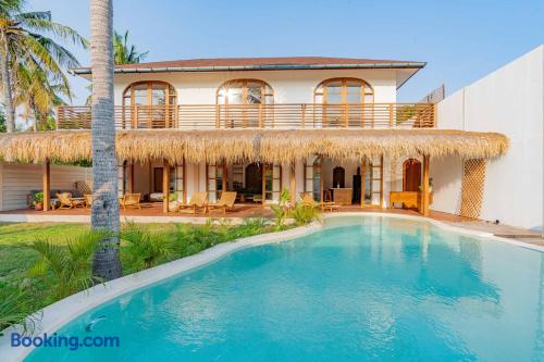 Tropical villa with private pool, shaded patio, and sunny balcony
