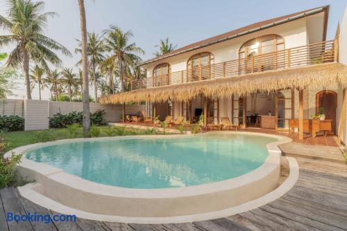Tropical villa with private pool, palm trees, and relaxing terrace