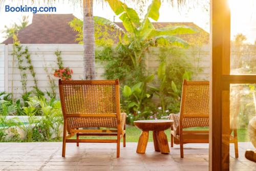Private tropical patio with lounge seating and garden views