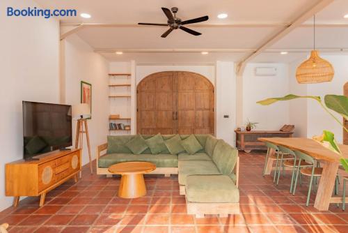 Bright open living space with stylish lounge, dining area, and rustic charm