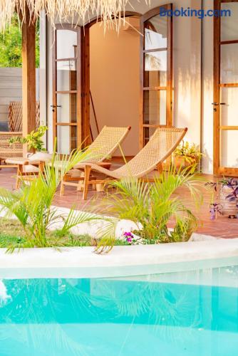 Tropical poolside terrace with loungers and charming indoor-outdoor style