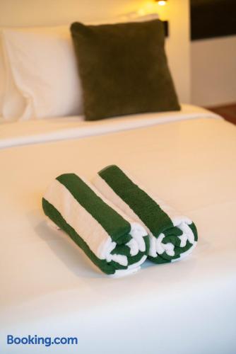 Crisp white bedding with fresh towels and a cozy, modern touch