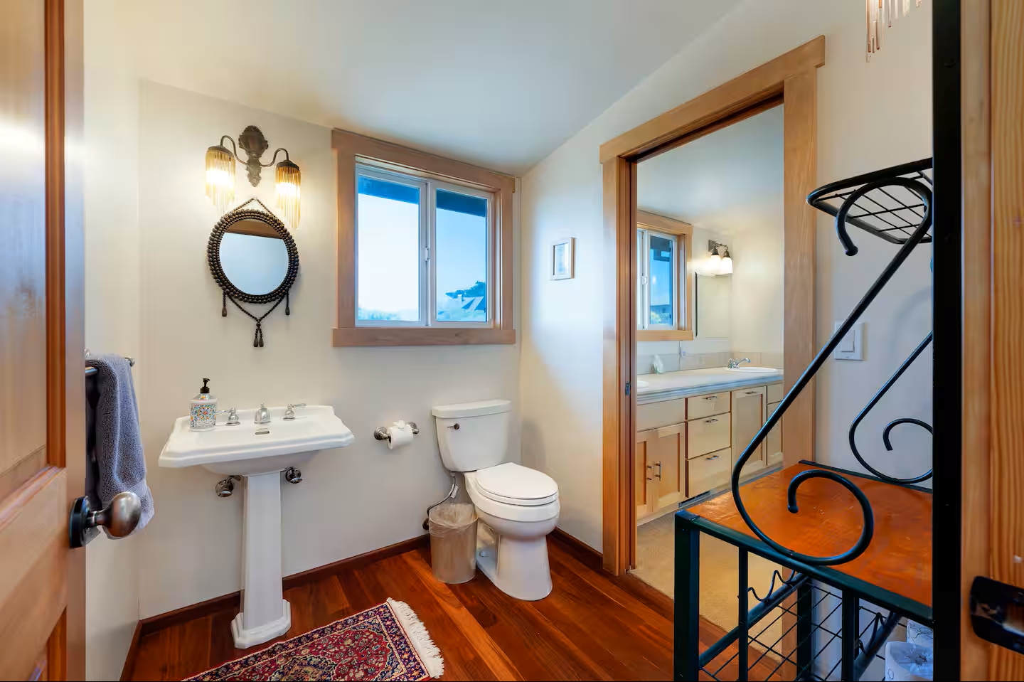 Bright bathroom with warm wood accents and adjoining vanity area