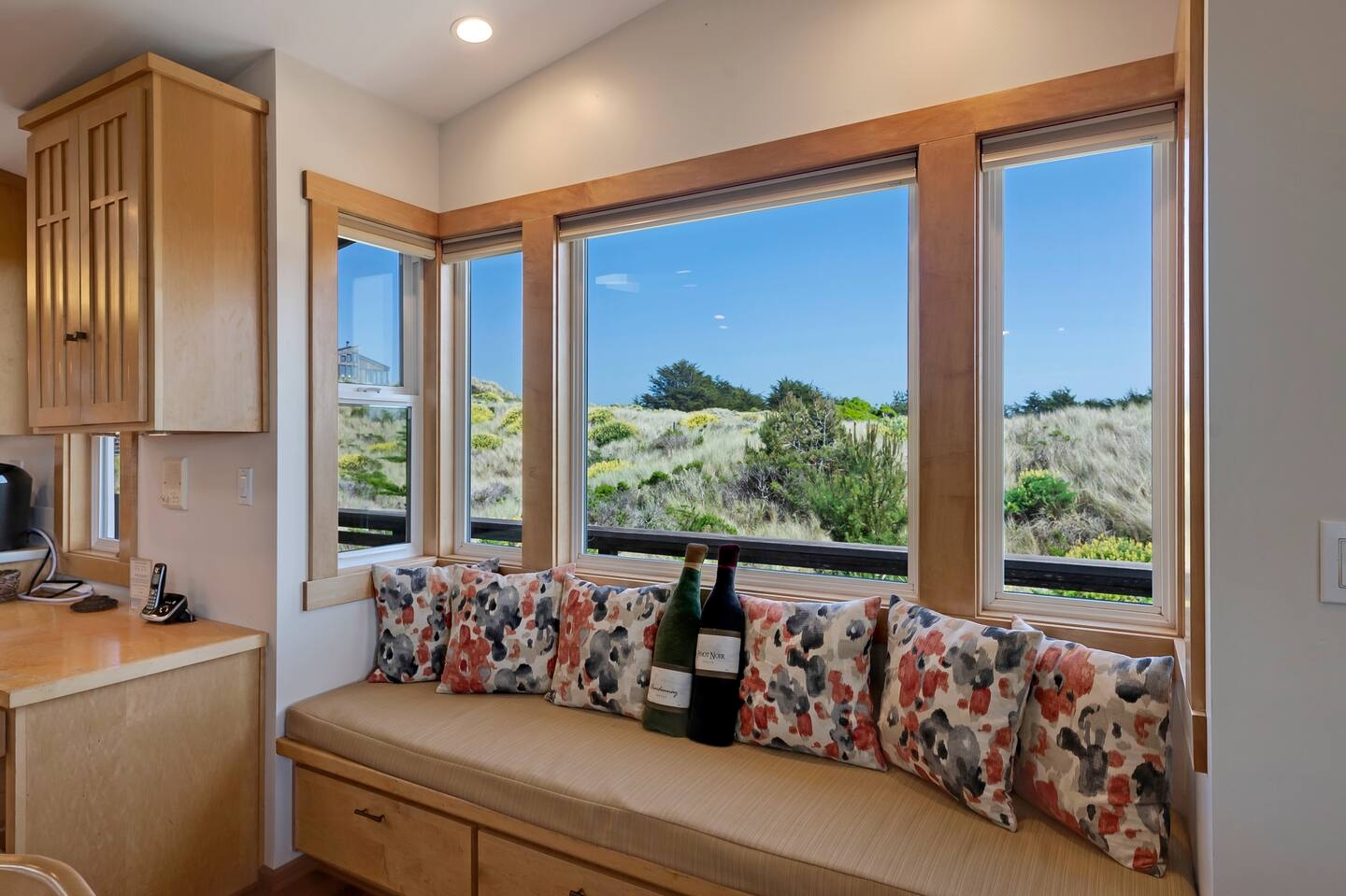 Cozy window seat with scenic dune views and abundant natural light