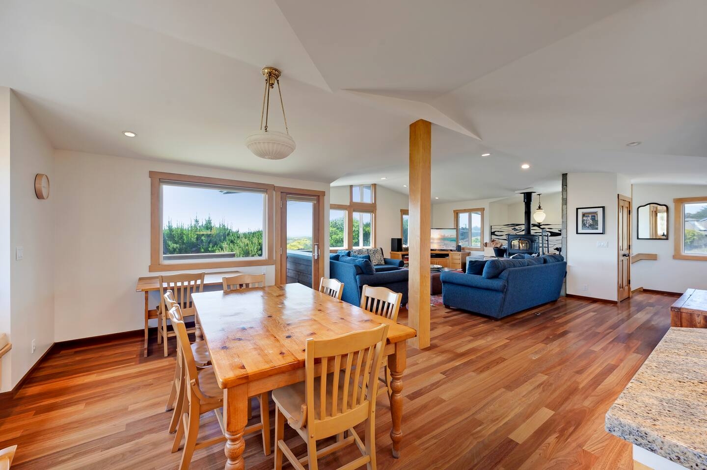 Bright open dining and living space with scenic views and warm wood finishes