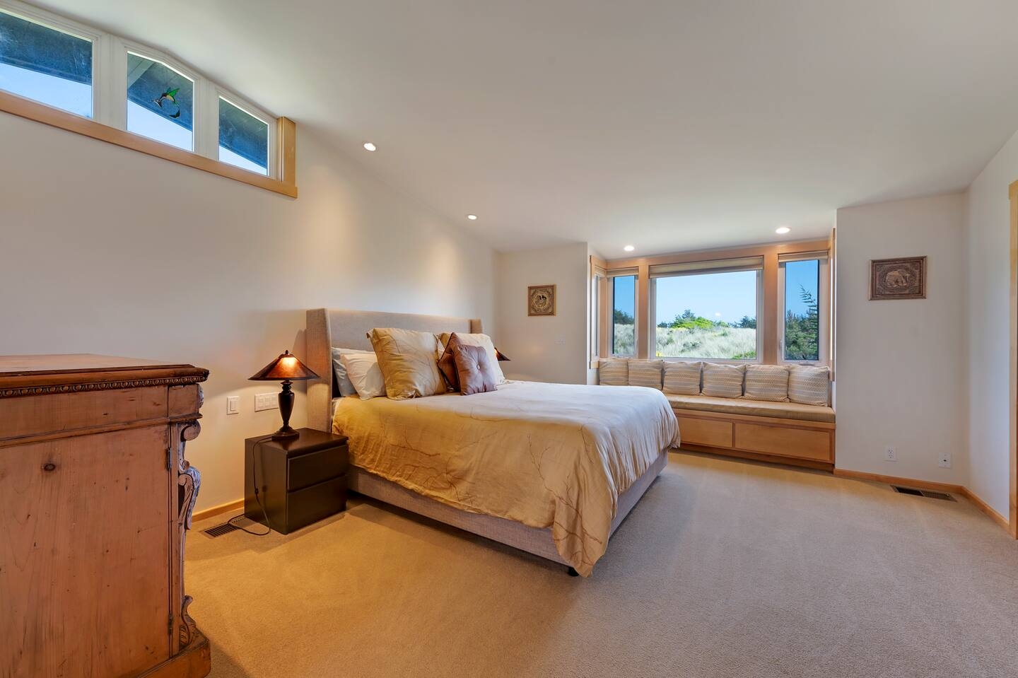 Spacious king bedroom with cozy window seat and scenic natural light
