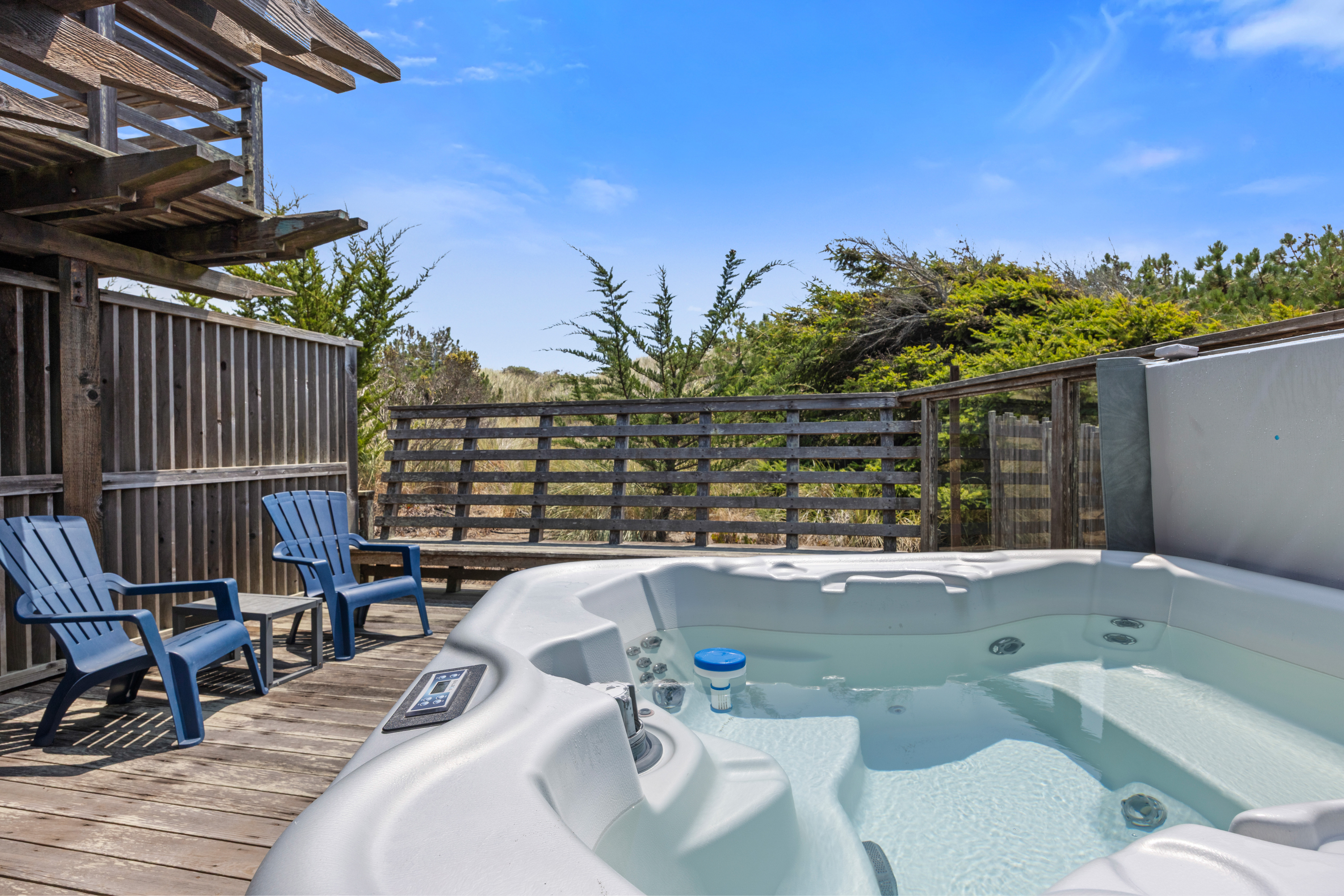 Private hot tub deck with outdoor seating and peaceful natural views