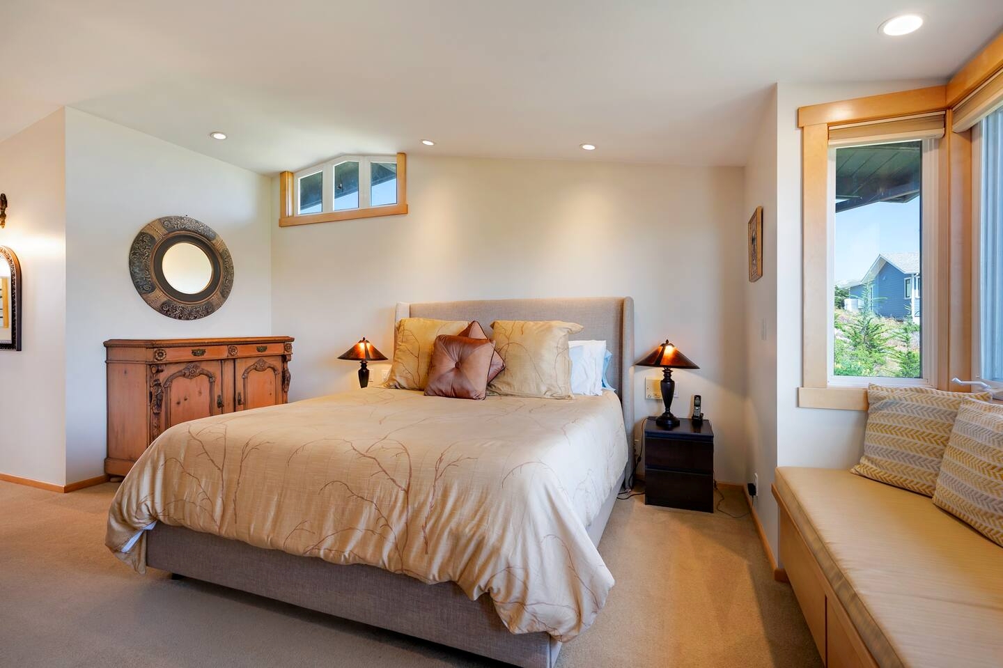 Cozy king bedroom with warm lighting, window seat, and stylish rustic touches