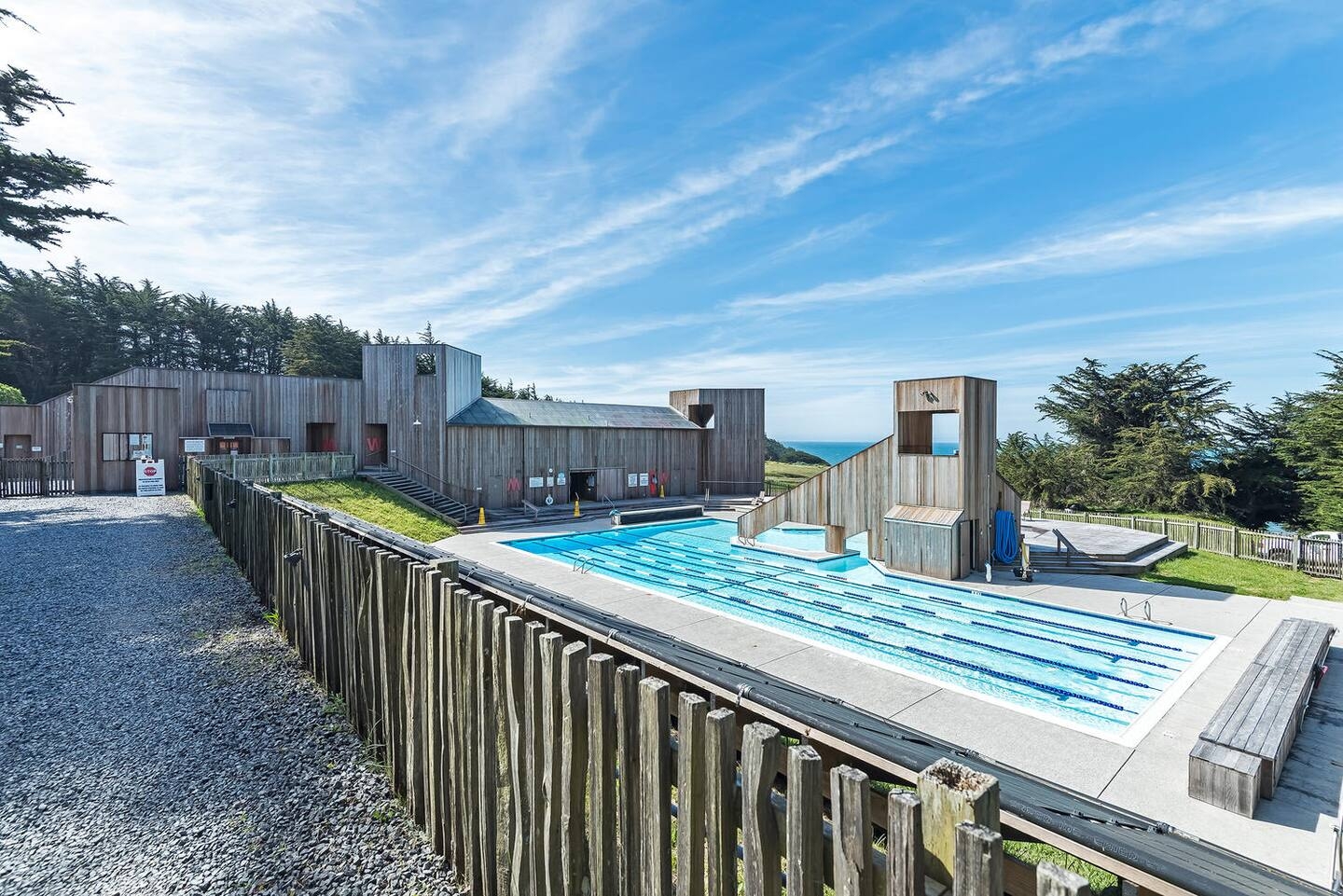 Resort-style outdoor pool with modern design and coastal views