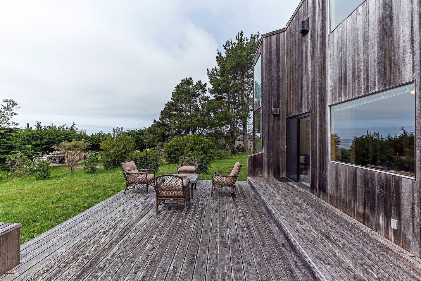 Spacious private deck with lounge seating and serene garden views