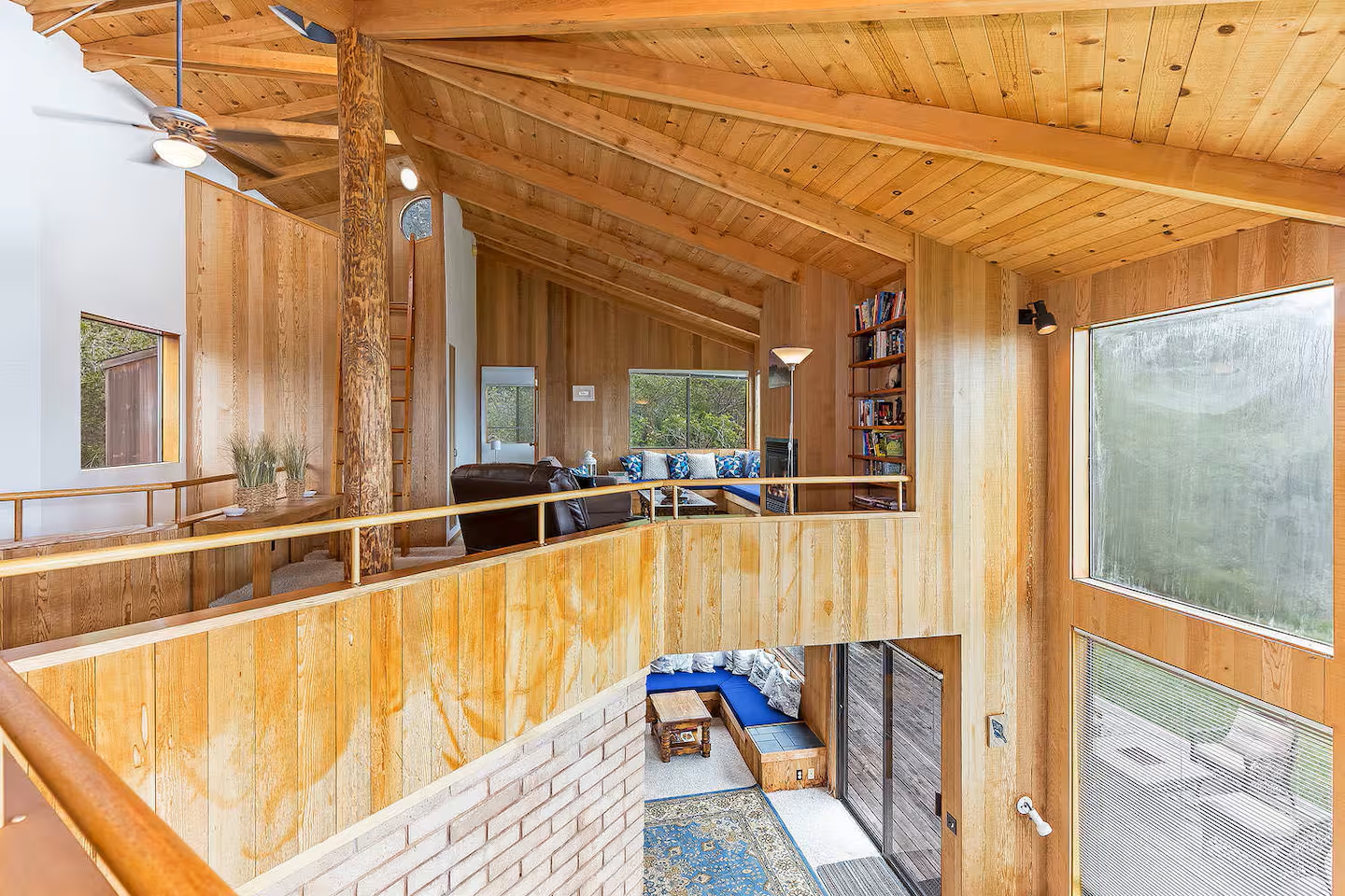 Vaulted wood interiors with loft overlook and bright, airy natural light
