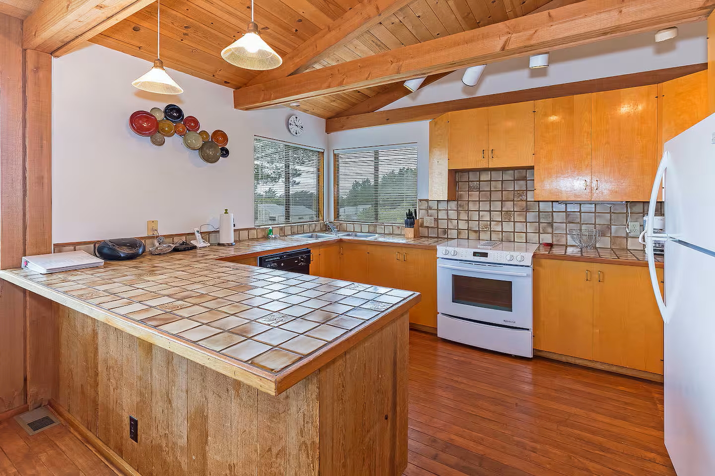 Warm wood-beamed kitchen with vaulted ceilings and a spacious island