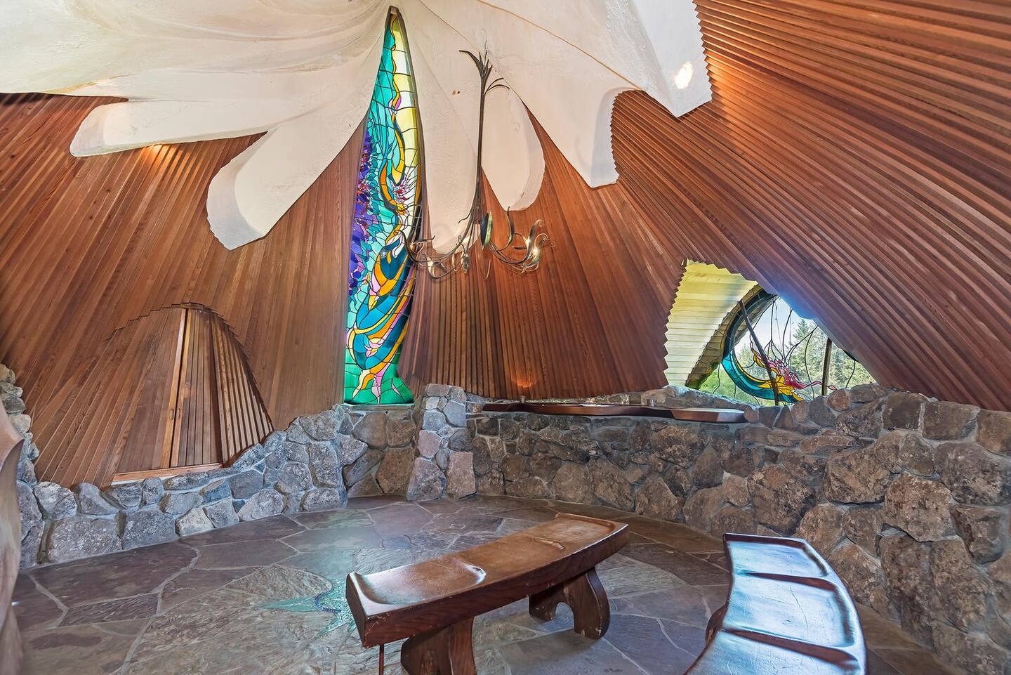 Dramatic wood-vaulted lounge with stained glass and stone details