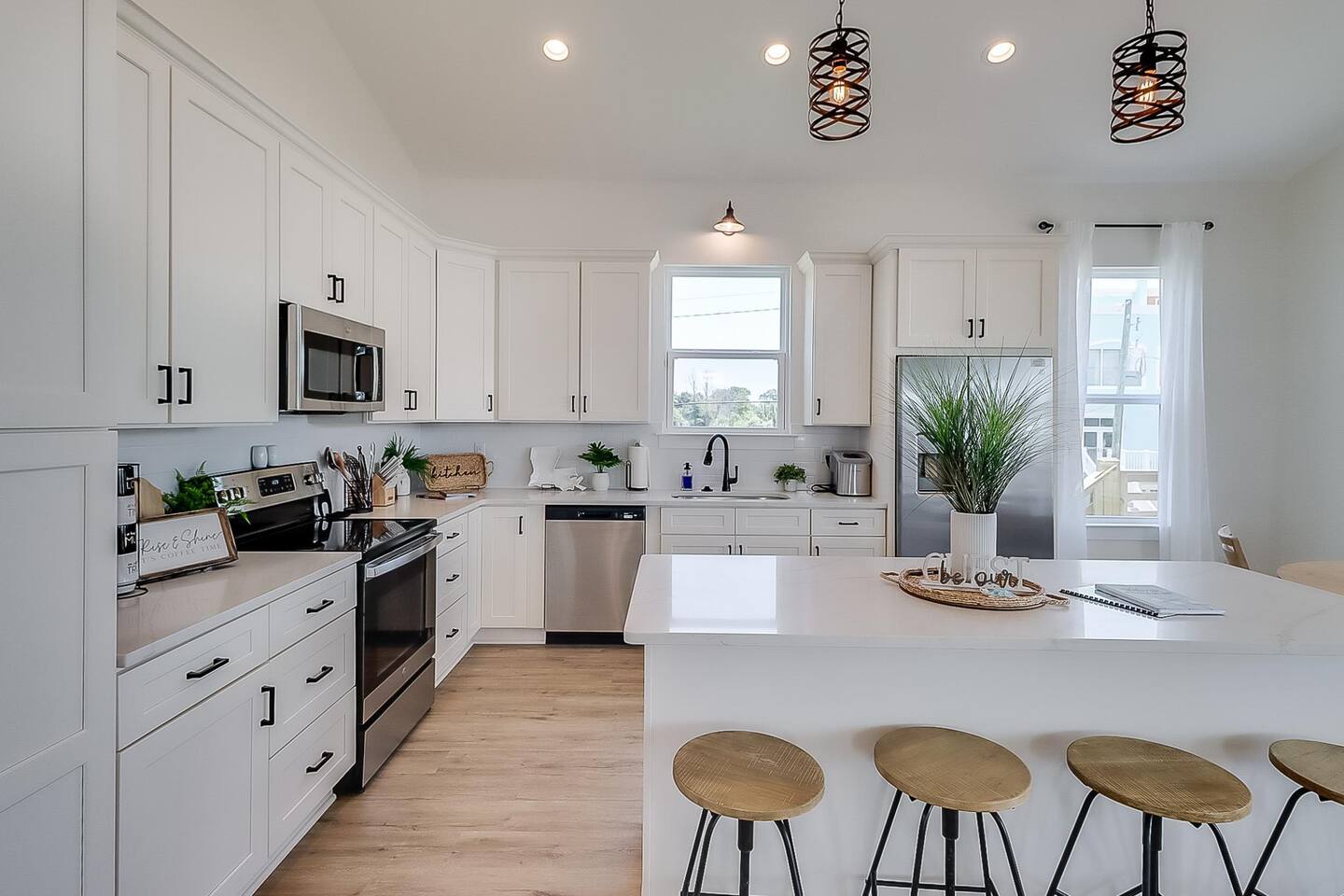 White kitchen with island and pendant lights