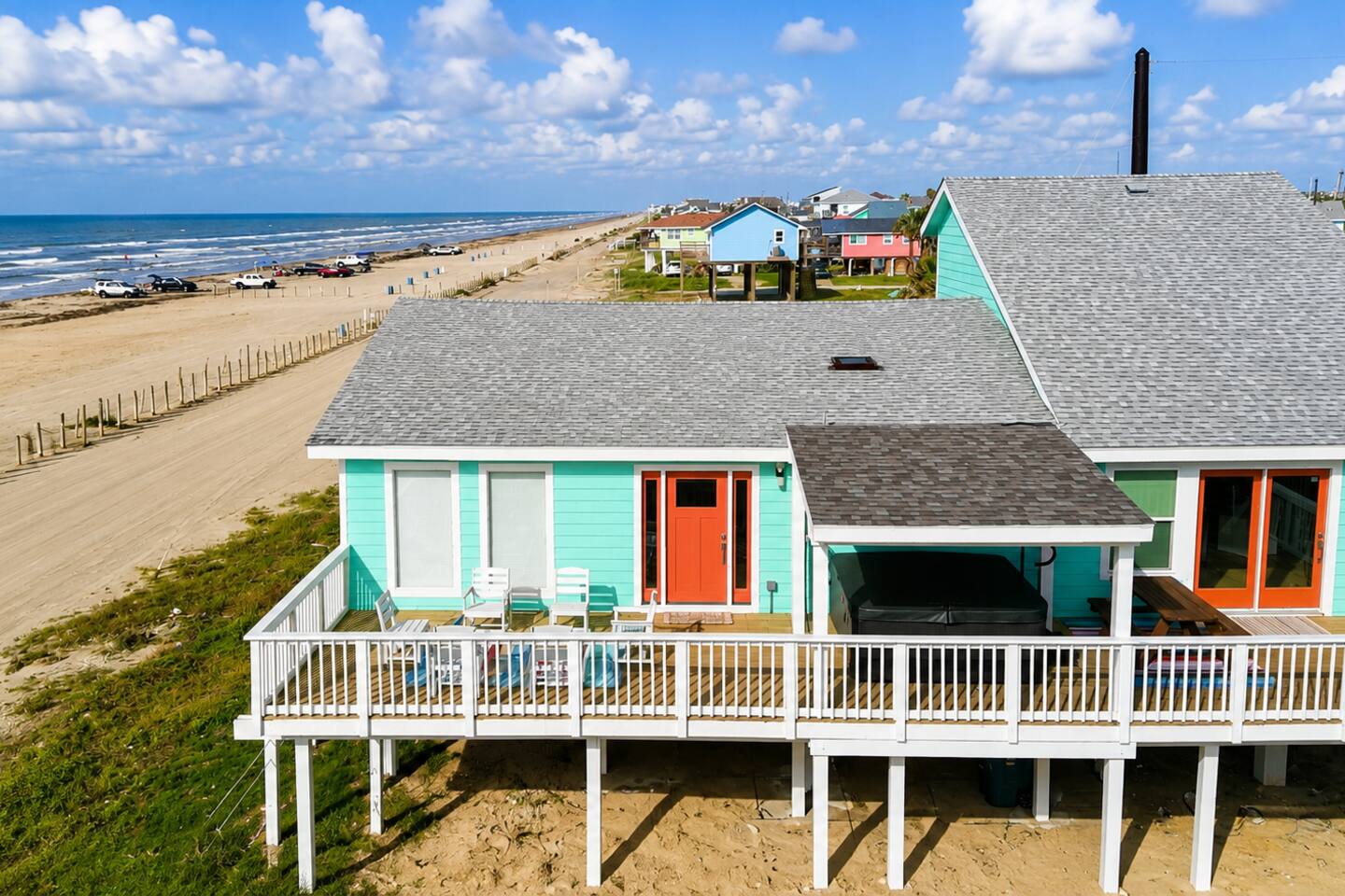 Teal beachfront house on stilts facing the Gulf