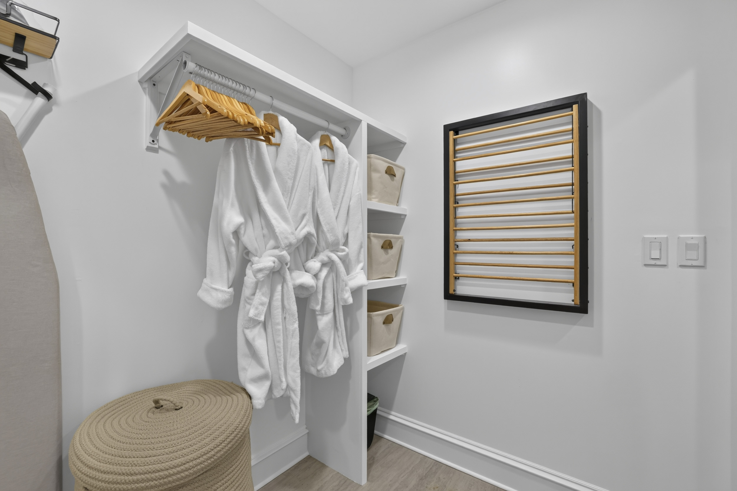 Thoughtful guest prep space with robes, storage, and modern convenience