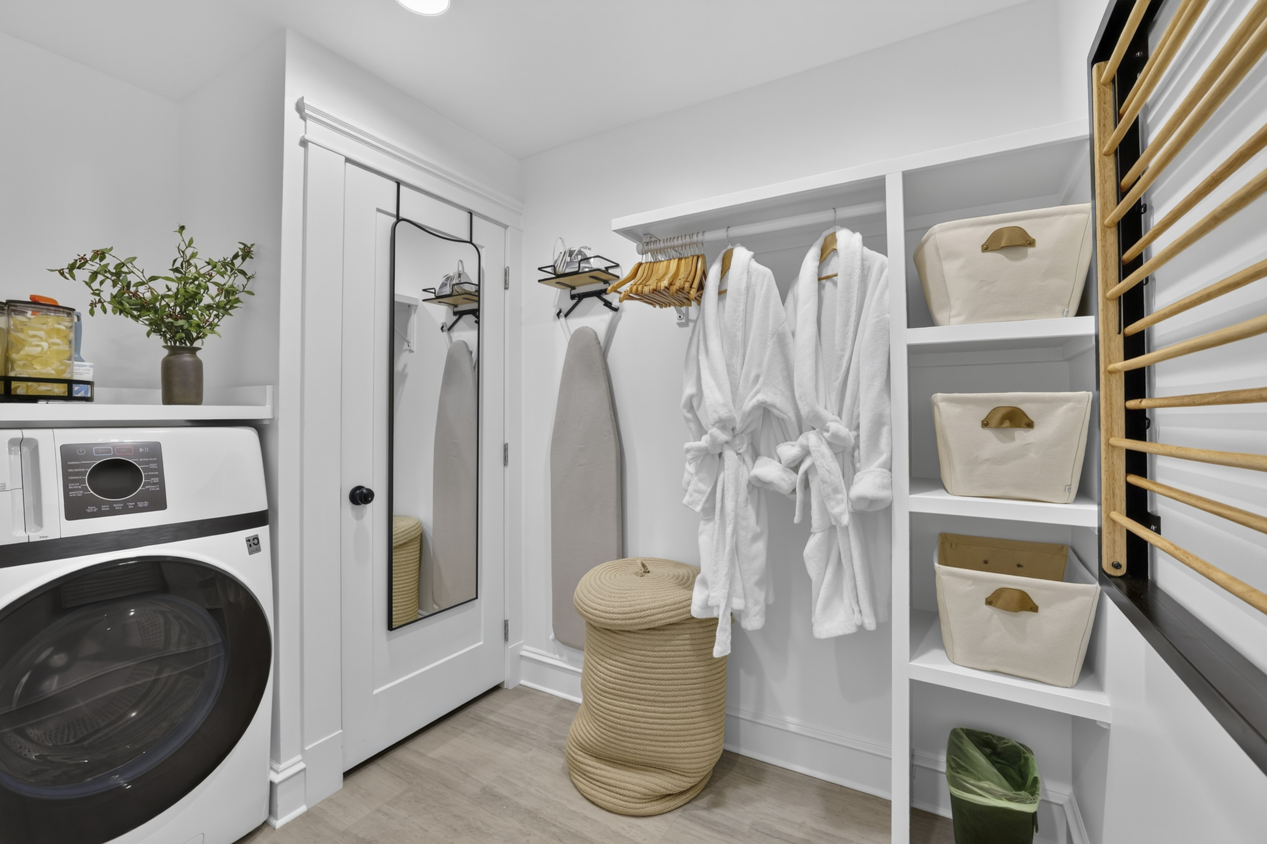 Bright laundry nook with robes, storage, and thoughtful guest essentials