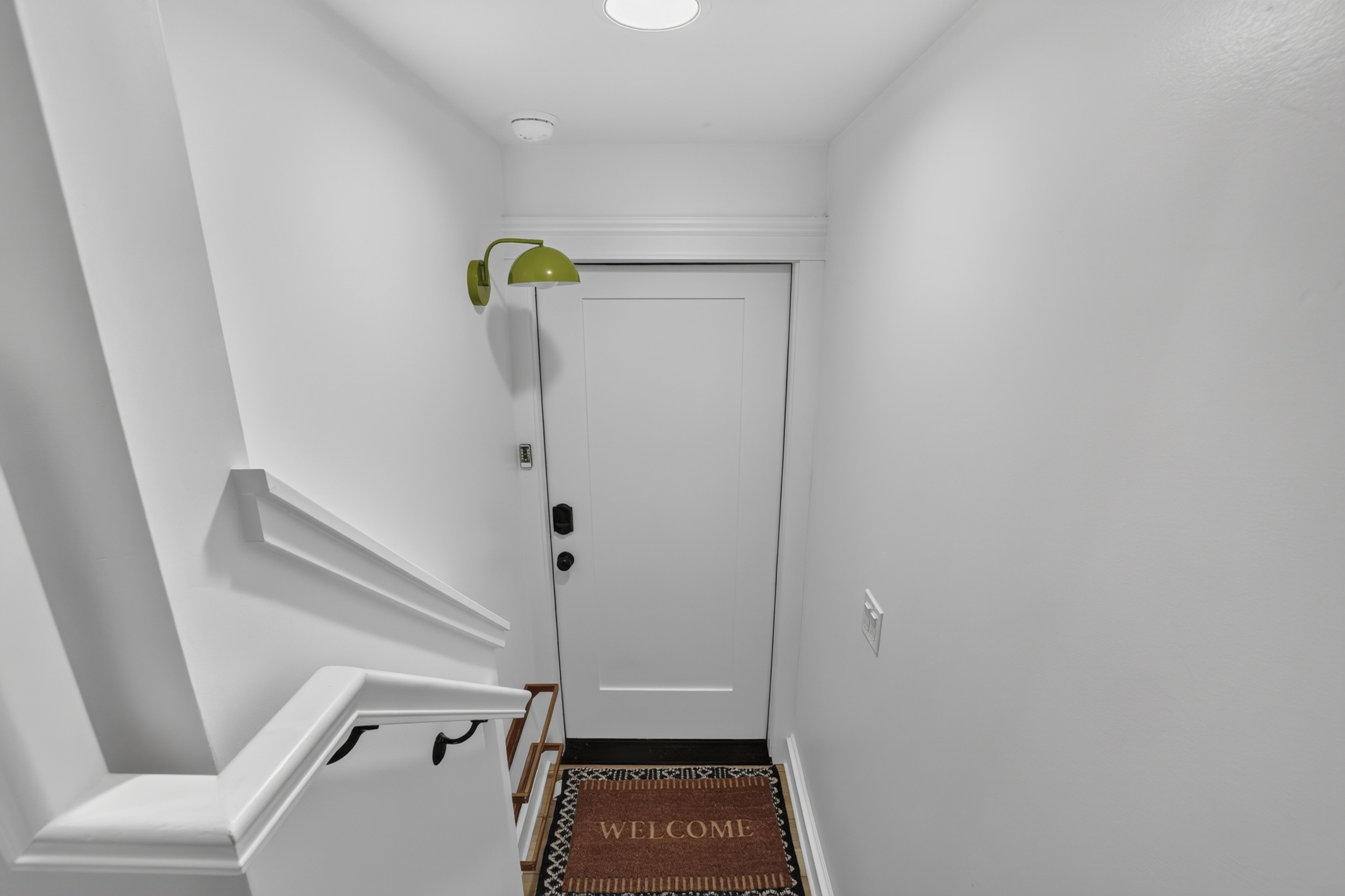 Bright, welcoming entryway with modern details and charming accents