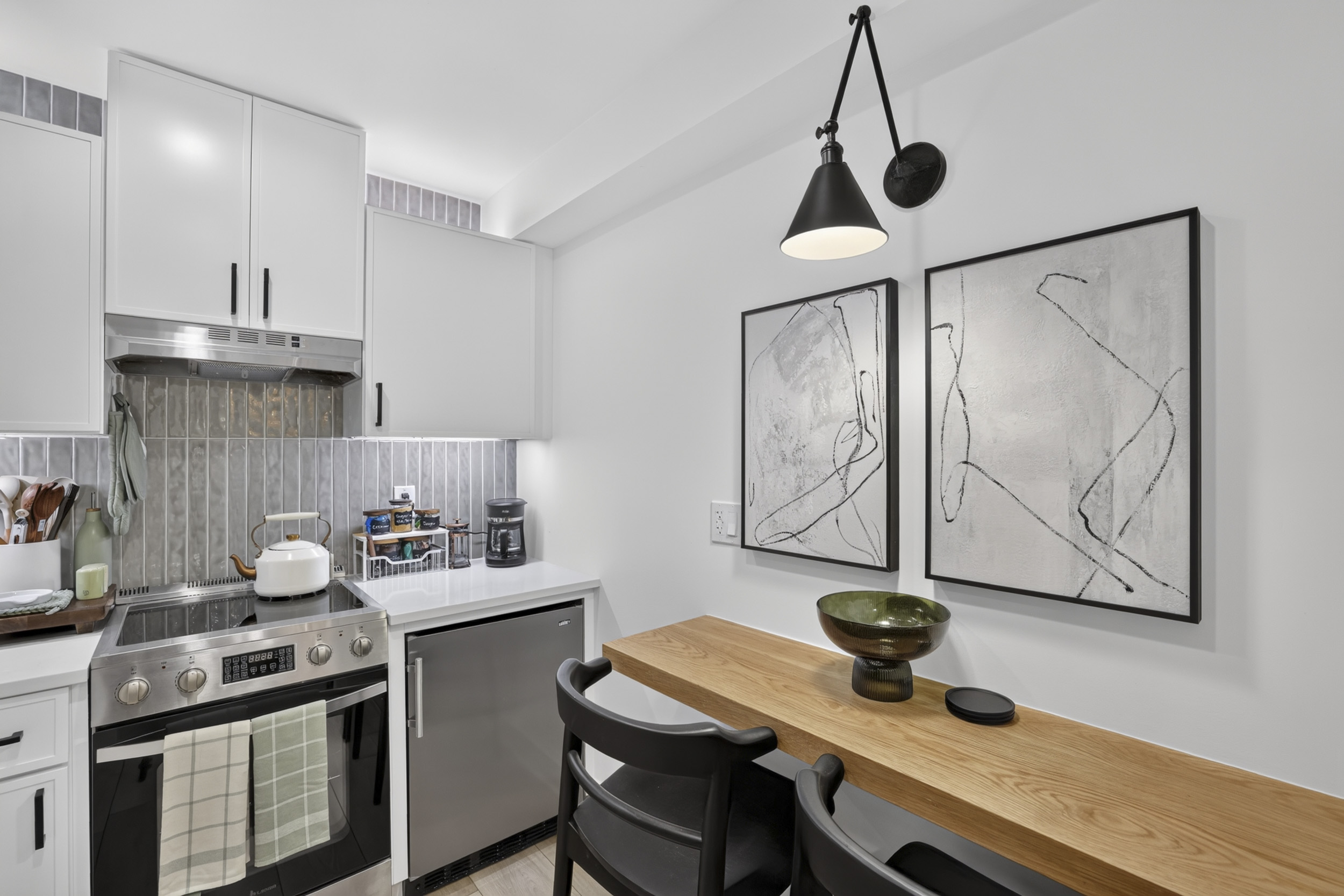 Modern kitchen with breakfast bar seating and sleek designer finishes